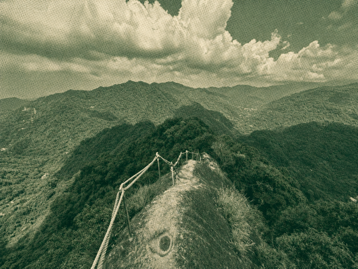 Narrow exposed mountain ridge with distant green peaks in Taiwan
